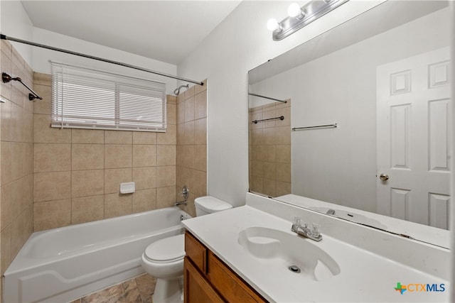 full bathroom with toilet, vanity, and tiled shower / bath