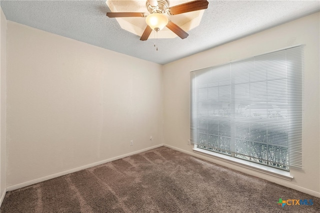 empty room with ceiling fan, carpet floors, and a textured ceiling