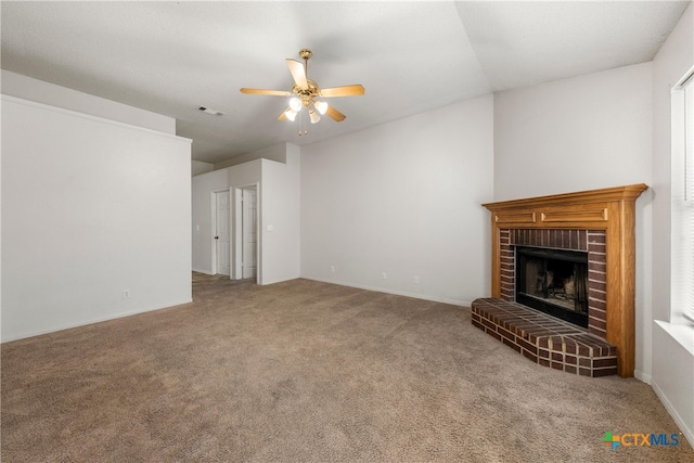 unfurnished living room with carpet flooring, ceiling fan, and a brick fireplace