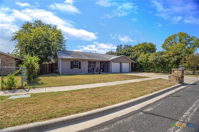 ranch-style home with a garage and a front lawn