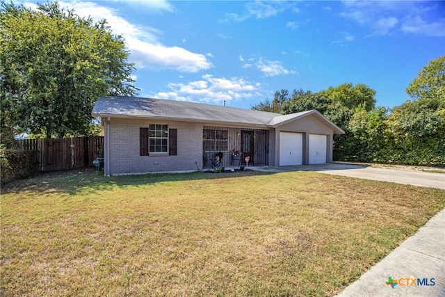 ranch-style home featuring a garage and a front yard