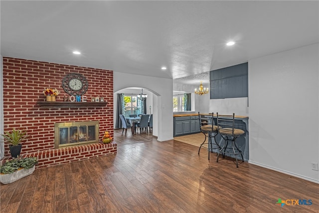 living room featuring a brick fireplace and hardwood / wood-style floors