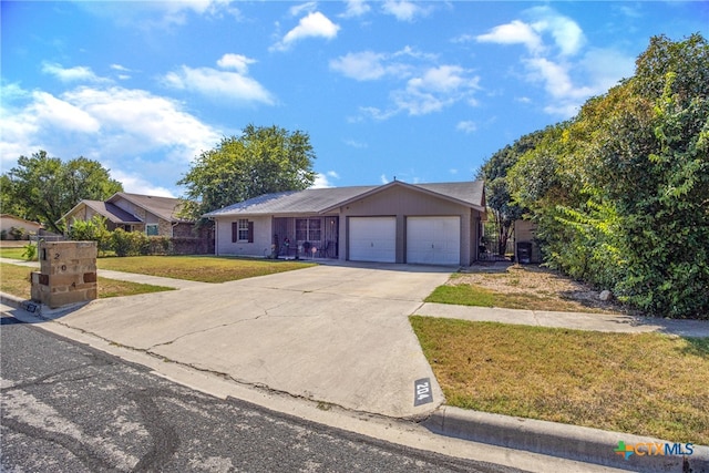 single story home with a garage and a front lawn