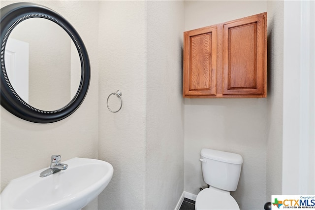 bathroom featuring sink and toilet