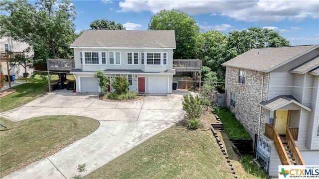 view of property with a garage and a front yard