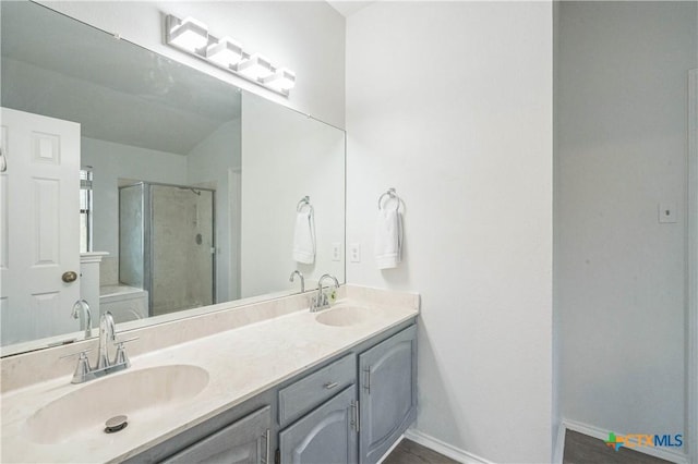 bathroom with toilet, vanity, and walk in shower