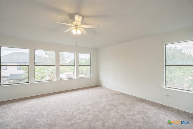 carpeted spare room featuring ceiling fan