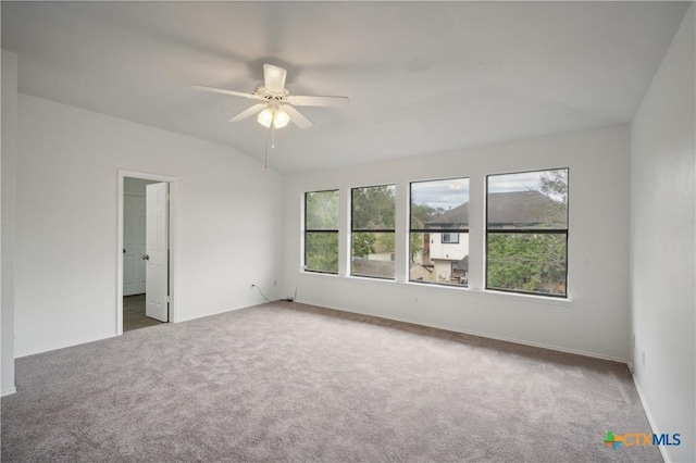 carpeted empty room with ceiling fan and vaulted ceiling