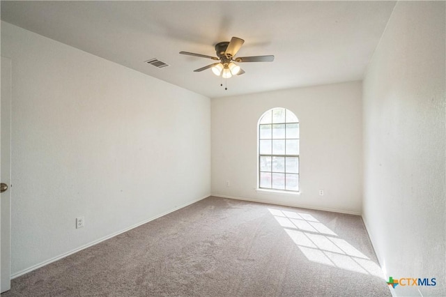 carpeted spare room with ceiling fan