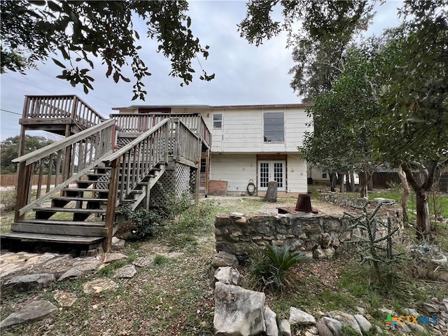 back of house with a wooden deck and french doors