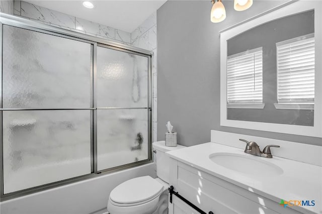 full bath with shower / bath combination with glass door, toilet, and vanity