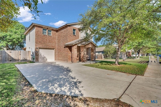 traditional-style home with brick siding, an attached garage, concrete driveway, and fence