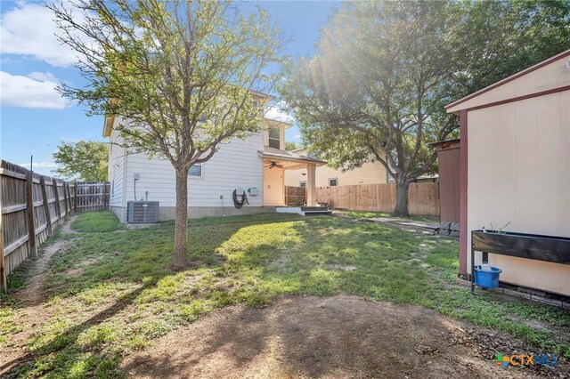 view of yard with a fenced backyard and central AC