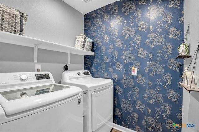 laundry room with washing machine and clothes dryer, laundry area, and wallpapered walls