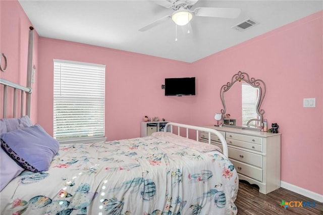 bedroom featuring baseboards, visible vents, ceiling fan, and dark wood finished floors