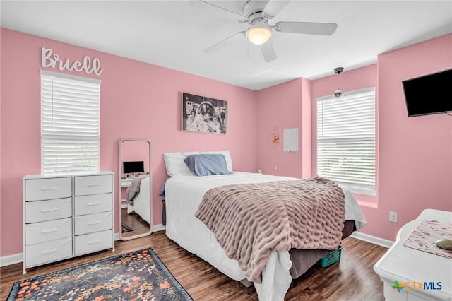 bedroom with baseboards, a ceiling fan, and wood finished floors