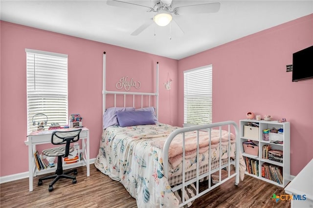 bedroom with baseboards, a ceiling fan, and wood finished floors