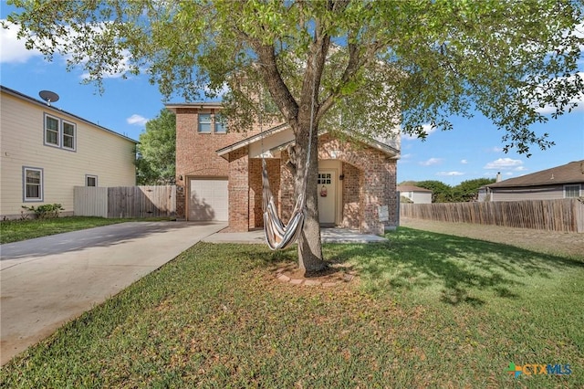 traditional home with fence, a front lawn, driveway, brick siding, and a garage