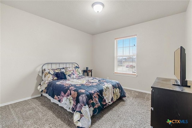 bedroom featuring carpet flooring and a textured ceiling