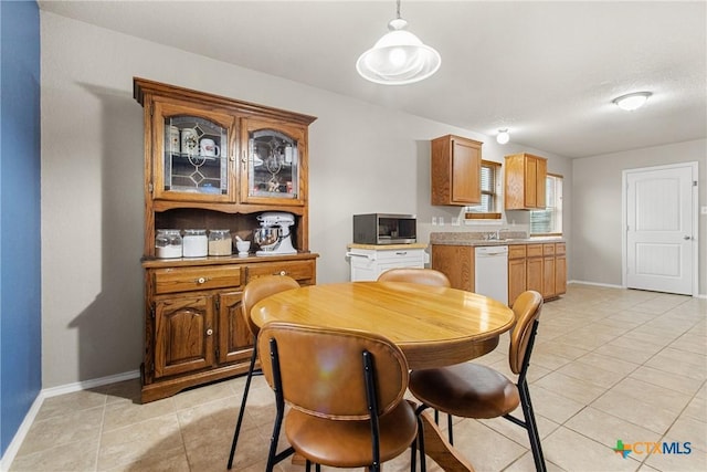 dining room with sink and light tile patterned flooring