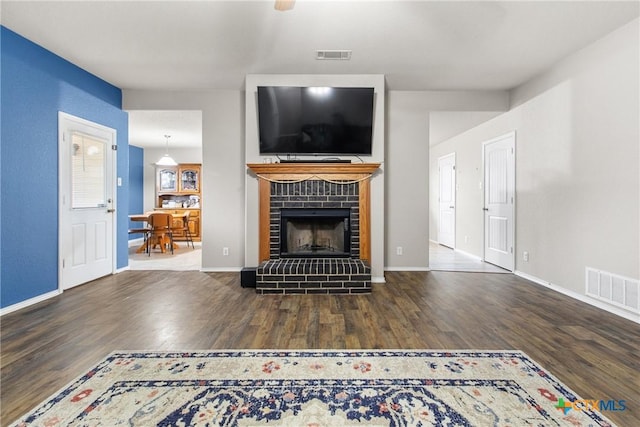 unfurnished living room featuring a fireplace and hardwood / wood-style floors