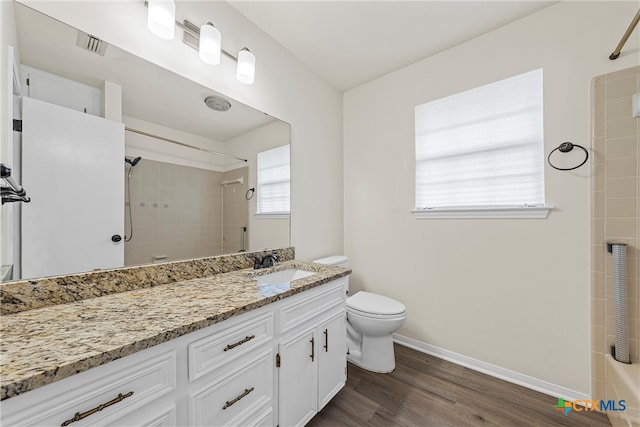 bathroom with hardwood / wood-style floors, vanity, and toilet