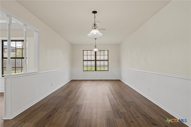 unfurnished dining area featuring dark wood-type flooring