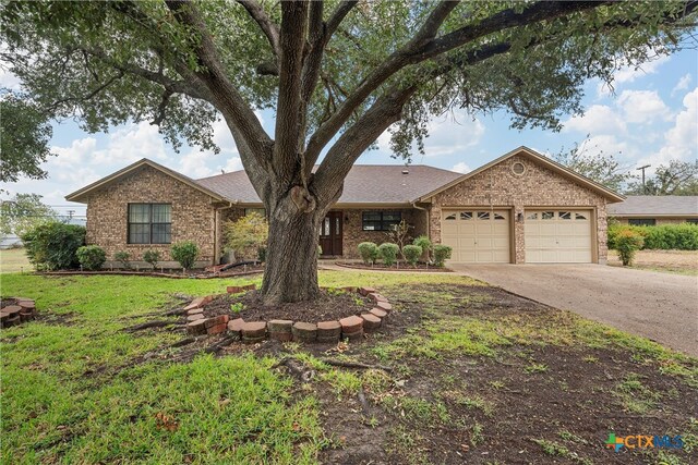 single story home with a garage and a front yard