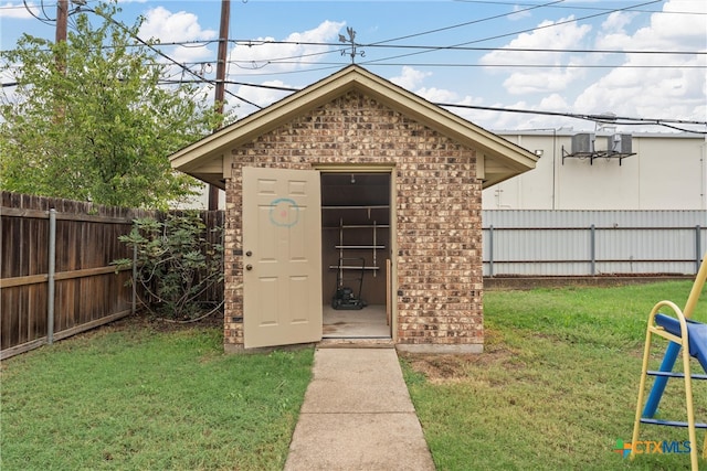 view of outbuilding featuring a lawn