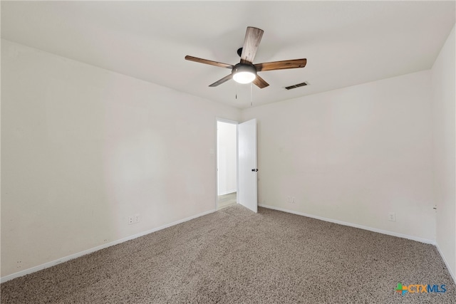 carpeted spare room featuring ceiling fan