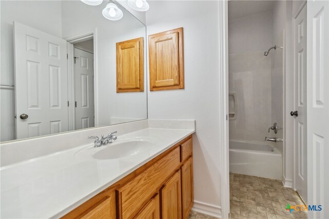 bathroom with washtub / shower combination and vanity