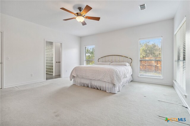 bedroom with ceiling fan and light carpet