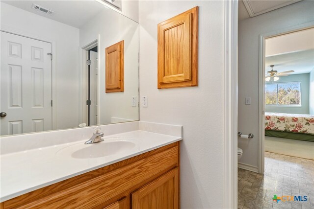 bathroom featuring ceiling fan, vanity, and toilet