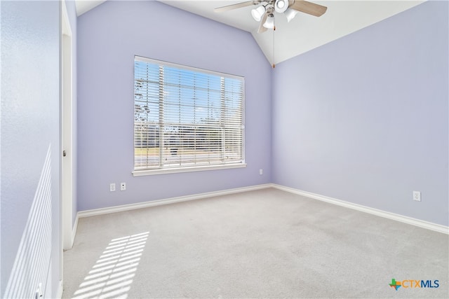 carpeted empty room with lofted ceiling and ceiling fan