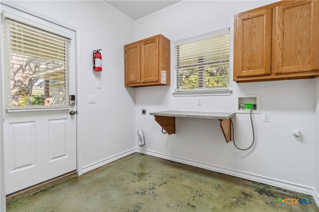 laundry area with hookup for a washing machine, electric dryer hookup, and cabinets