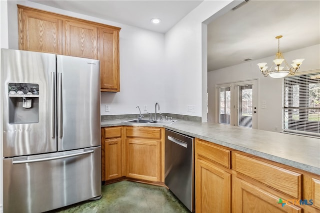 kitchen featuring sink, kitchen peninsula, appliances with stainless steel finishes, hanging light fixtures, and a notable chandelier