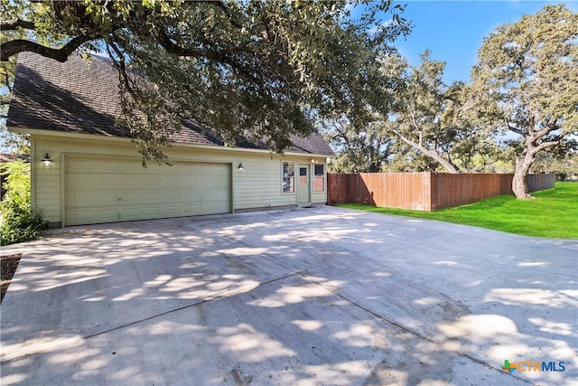 view of home's exterior featuring a garage and a yard