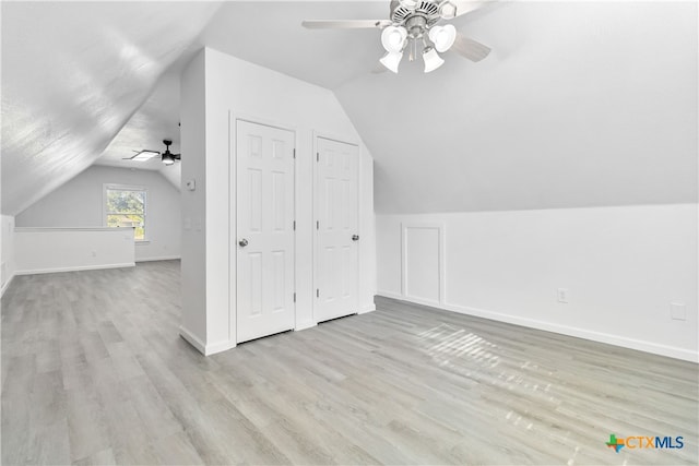 additional living space featuring vaulted ceiling, ceiling fan, and light hardwood / wood-style flooring