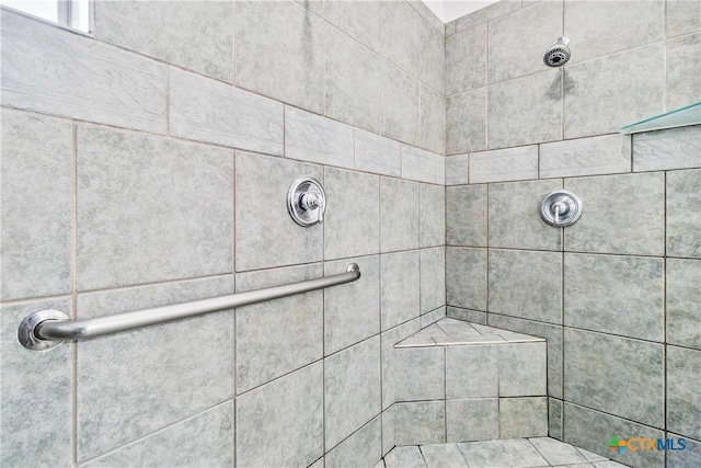 bathroom with tiled shower