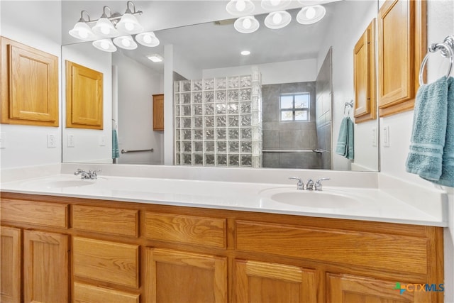 bathroom featuring vanity and tiled shower