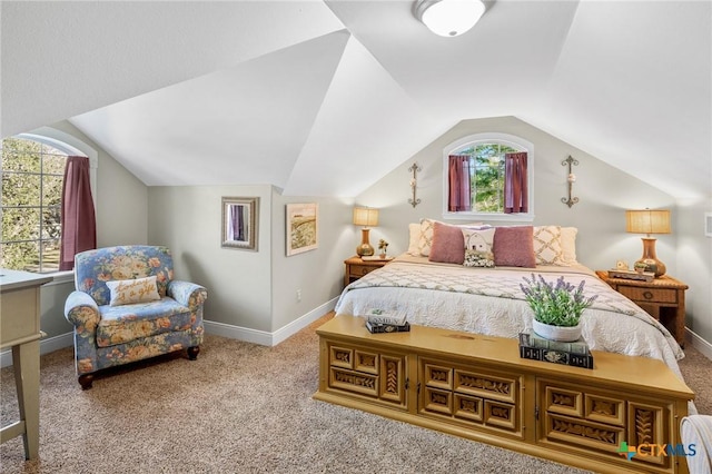 carpeted bedroom with lofted ceiling