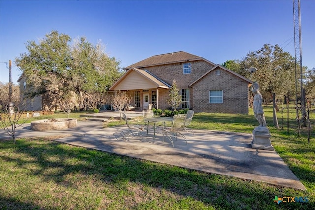 rear view of property with a patio area and a yard