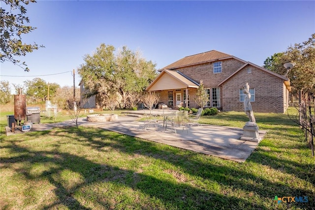 rear view of property with a patio area and a lawn