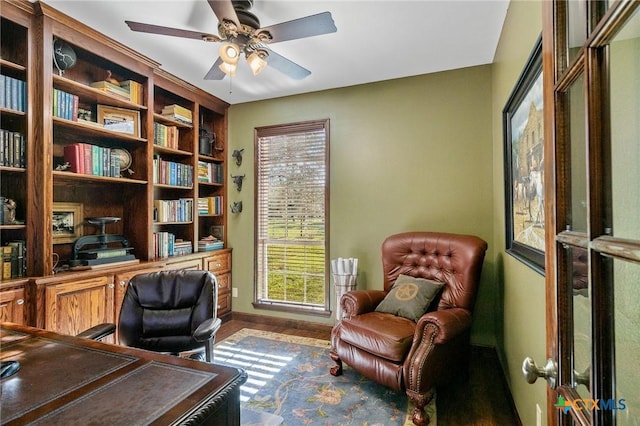 office space featuring built in shelves, a wealth of natural light, and ceiling fan