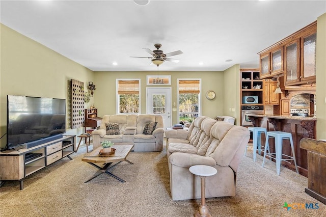 living room featuring light colored carpet and ceiling fan