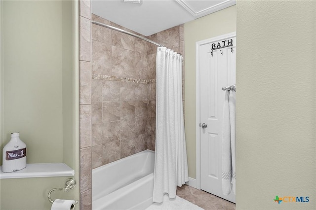 bathroom with tile patterned floors and shower / tub combo