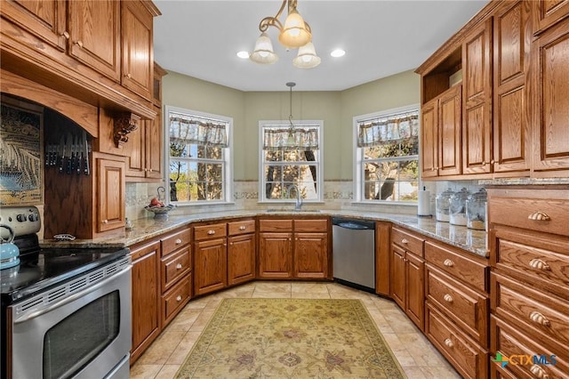 kitchen featuring appliances with stainless steel finishes, backsplash, hanging light fixtures, and a healthy amount of sunlight