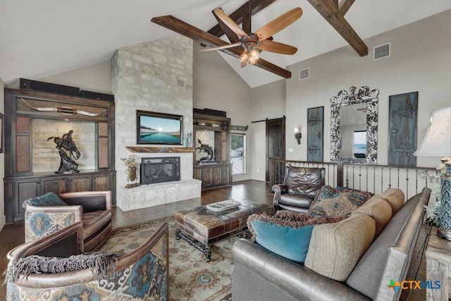 1746 Stagecoach Dr, Canyon Lake, TX 78133 - living room featuring a ceiling fan, beamed ceiling, wood finished floors, high vaulted ceiling, and a barn door