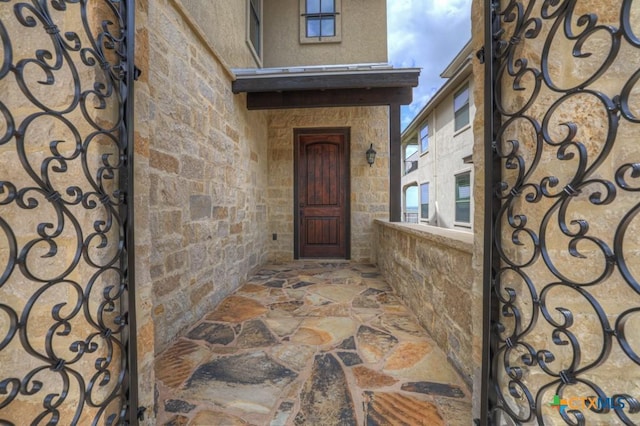 1746 Stagecoach Dr, Canyon Lake, TX 78133 - view of exterior entry featuring stone siding and a gate