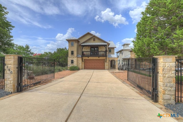 1746 Stagecoach Dr, Canyon Lake, TX 78133 - view of front of home with a gate, an attached garage, a standing seam roof, and a metal roof